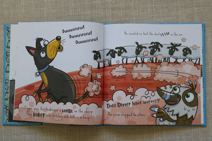 An open Australian children's book spread laid on a beige textured fabric background. The illustrated pages show a cartoon dog and a bird with text and a worm-themed scene.